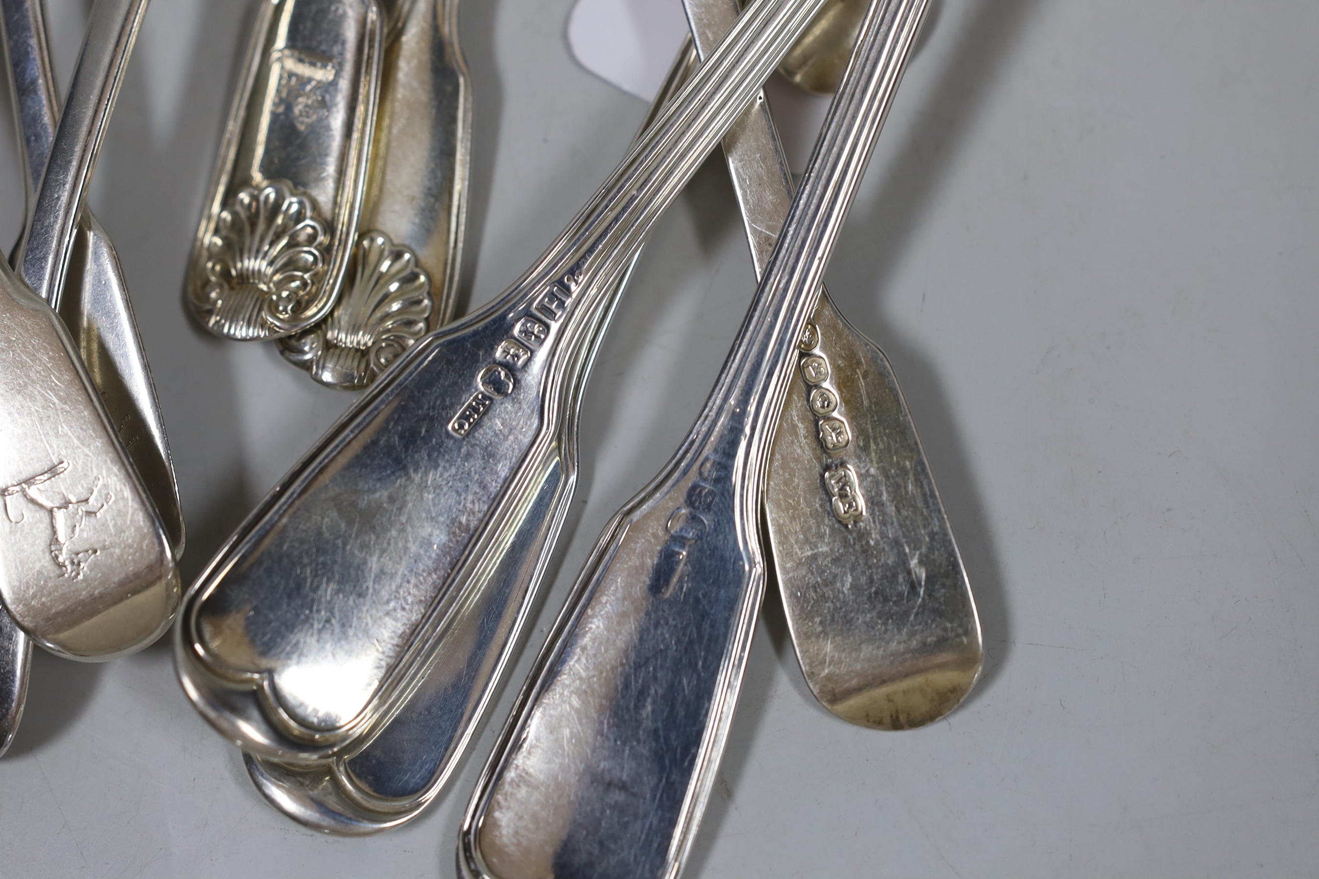 Eleven items of 19th century silver flatware, including a set of three Scottish silver fiddle and thread pattern table spoons, 19.8oz.